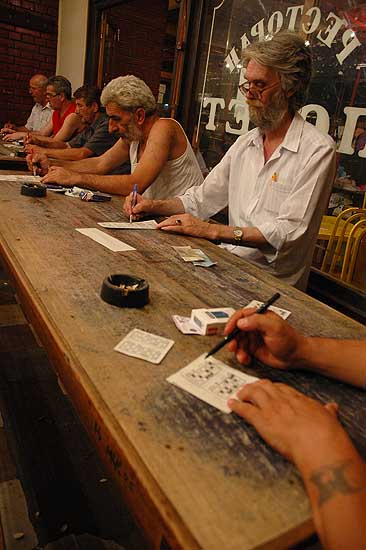 autor: Yves Rousselet
t&iacute;tulo: Joueurs concentrés sur leur grille dans une salle de loto